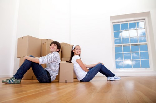 Loading furniture into a removals van on a residential street