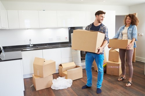 Worker assessing lifting risks before moving household items