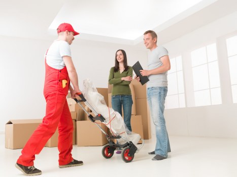 Moving team handling furniture in a Finchley flat or maisonette