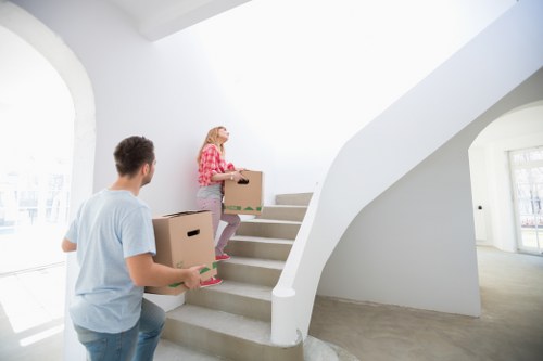 Removal crew carrying furniture from a Finchley apartment building